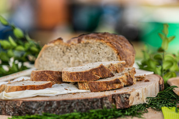 Closeup details of fresh baked bread. Loaf of fresh bread on wooden surface