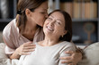 © fizkes - Loving adult daughter kiss senior mother relaxing together