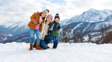 happy family mother and children having fun on winter walk