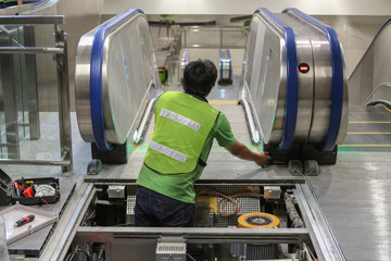 Technician fix the  escalator in railway station or building for passenger go up or go down between floor level 