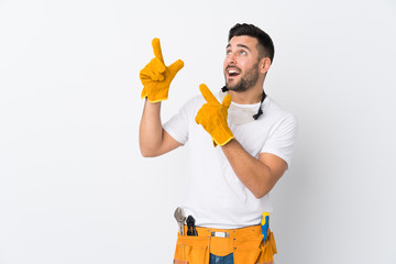 Poster - Craftsmen or electrician man over isolated white background pointing with the index finger a great idea