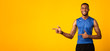 © Prostock-studio - Happy afro guy pointing at copyspace for promo