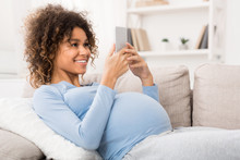 African-american Pregnant Woman Browsing On Smartphone, Free Space