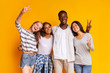 © Prostock-studio - Carefree international students having fun over yellow background