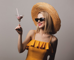 Wall Mural - beatiful girl with cocktail in hat and yellow dress