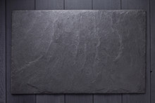 Slate Stone Nameplate Or Wall Sign At Wooden Background