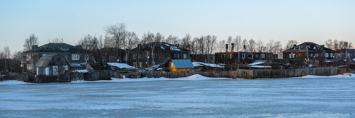 Canvas Print - House on a bank of White sea in Rabocheostrovsky, Karelia, Russia, in winter at sunset.