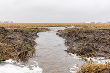 January Storms With Heavy Rain Caused Flash Flooding In Illinois Farm Field, Overflowing Ditches And Soil Erosion From Flowing Water Runoff