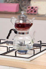 Wall Mural - Glass teapot on wooden counter of open plan kitchen