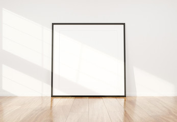 Aufkleber - Black frame leaning in bright white interior with wooden floor mockup 3D rendering