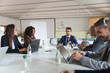 © Mangostar - Focused leader communicating with workers. Thoughtful employees sitting at table during morning briefing. Business meeting concept