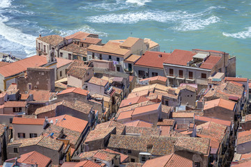 Wall Mural - Aerial view on a buildings tiled roofs in historic part of Cefalu city, view from Cefalu Rock on Sicily Island in Italy