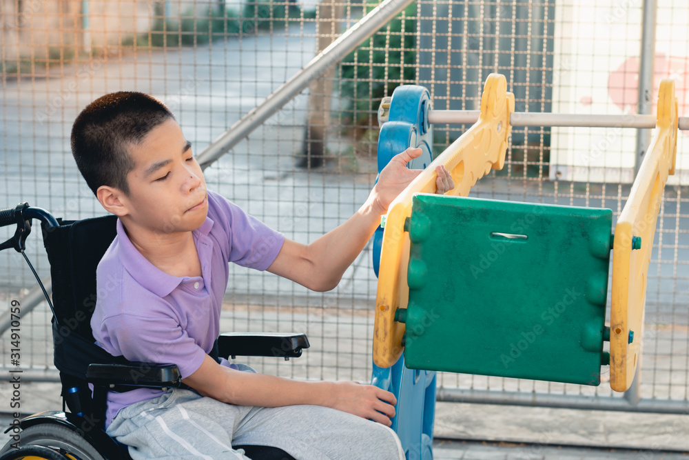 Disabled child on wheelchair is playing,learning and exercise in the ...