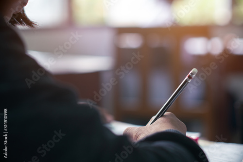 Cuadros en Lienzo Hand of Student doing test or exam in classroom of school with stress
