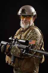 Wall Mural - Military veteran with sniper rifle isolated on black.