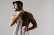 © Oleh Phoenix - Sexy sport muscle strongface guy with white towel on grey isolated  font background