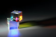 Two bright luminous prism cubes refract light in different colors