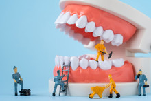 Miniature People Of The Teeth Cleaning Workers Are Medical And Health Care Concepts.