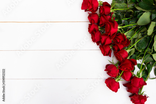 Red blooming roses on wood