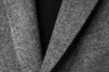 close up of mens grey wool blazer combined with black traditional polo. low dof.