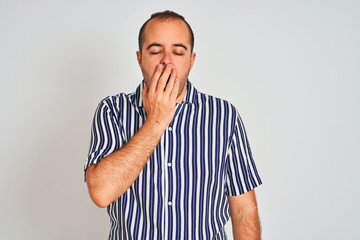 Sticker - Young man wearing blue striped shirt standing over isolated white background bored yawning tired covering mouth with hand. Restless and sleepiness.