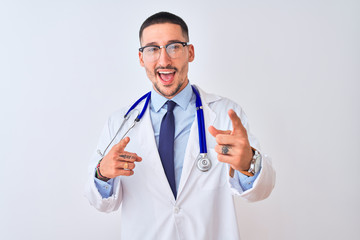 Wall Mural - Young doctor man wearing stethoscope over isolated background pointing fingers to camera with happy and funny face. Good energy and vibes.