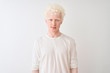 © Krakenimages.com - Young albino blond man wearing casual t-shirt standing over isolated white background Relaxed with serious expression on face. Simple and natural looking at the camera.