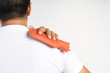 © bonnontawat - Hand holding hot water bag for pain relief at shoulder