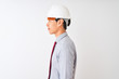 © Krakenimages.com - Chinese architect man wearing tie and helmet standing over isolated white background looking to side, relax profile pose with natural face with confident smile.