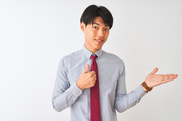 Wall Mural - Chinese businessman wearing elegant tie standing over isolated white background Showing palm hand and doing ok gesture with thumbs up, smiling happy and cheerful