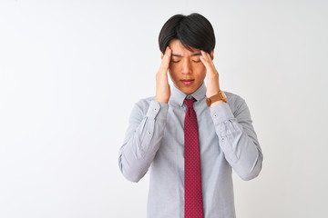 Wall Mural - Chinese businessman wearing elegant tie standing over isolated white background with hand on headache because stress. Suffering migraine.