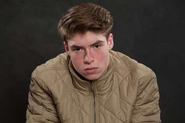 Wall Mural - Portrait of serious young man in studio