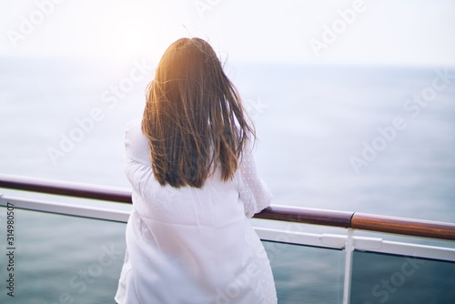 Fotografía Young beautiful woman on vacation standing on a deck of ship with smile on face