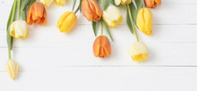 Yellow Tulips On Wooden Background