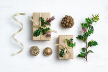 Australia Christmas Background Concept. Gifts, Gold Pine Cones, Australian Native Plant Grevillea Foliage And Gold Ribbon Make Up This Natural Flat-lay Composition On A White Background.