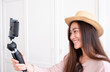 © weedezign - Asian young female blogger recording vlog video with mobile phone live streaming when travel.online influencer on social media viral concept