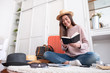 © weedezign - Young asian woman traveler prepare cloth and stuff into orange suitcase for holiday vacation at home.backpacker travel concept