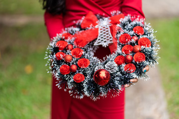 Wall Mural - Advent Christmas wreath hold on young lady