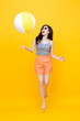 © Atstock Productions - Happy young Asian woman in casual summer clothes playing beach ball
