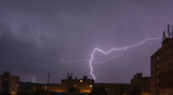 Fototapeta Tęcza - lightning over buildings at night
