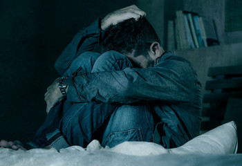 dramatic portrait of depressed and sick man suffering from psychosis illness or mental disorder look