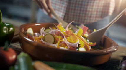 Wall Mural - Woman preparing mixed vegetables in a bowl