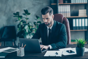 Poster - Photo of handsome business guy notebook table chatting with colleagues partners seriously reading corporate report wear black blazer white shirt suit sitting chair office indoors