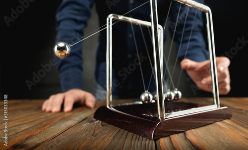 Cuadros en Lienzo Concept For Action and Reaction in Business With Newton's Cradle with Businessma