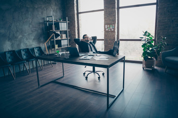 Wall Mural - High angle above view photo of handsome business guy relaxing legs on table toothy smiling hands behind head wear specs black blazer shirt pants tie suit sit chair office indoors