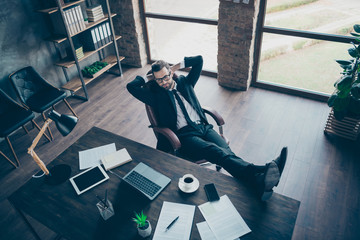 Sticker - High angle above view photo of handsome business guy drink coffee relaxing break legs on table looking notebook screen wear specs black blazer shirt pants tie suit sit chair office indoors