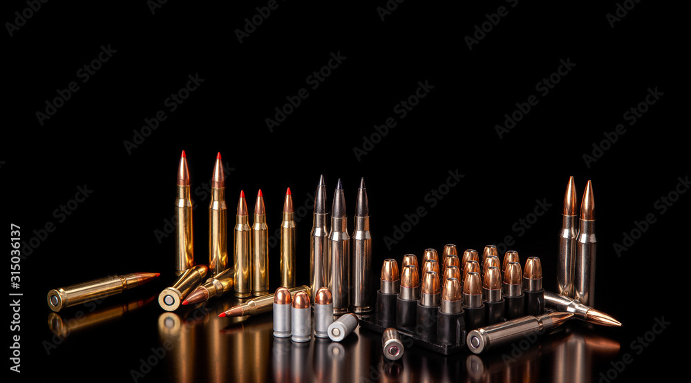 Bullet isolated on black background with reflexion. Rifle bullets close-up on black back. Cartridges for rifle and carbine on a black. - obrazy, fototapety, plakaty 