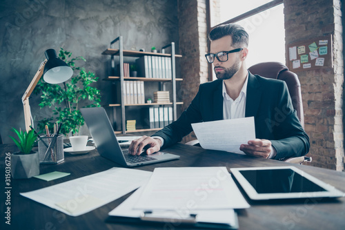 Cuadros en Lienzo Photo of handsome business brunet guy looking notebook table reading paper repor