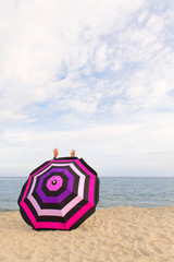 Canvas Print - Happy at thbe beach behind Beach umbrella for shadow