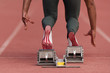 Back view of female feet on starting block ready for a sprint start